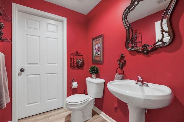 6104 W 144th St, Overland Park, KS 66223 - bathroom featuring toilet, wood finished floors, and baseboards