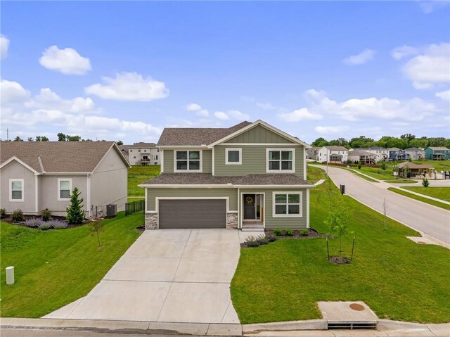 19637 W 196th St, Spring Hill, KS 66083 - view of front of home featuring concrete driveway, central AC, an attached garage, stone siding, and a residential view
