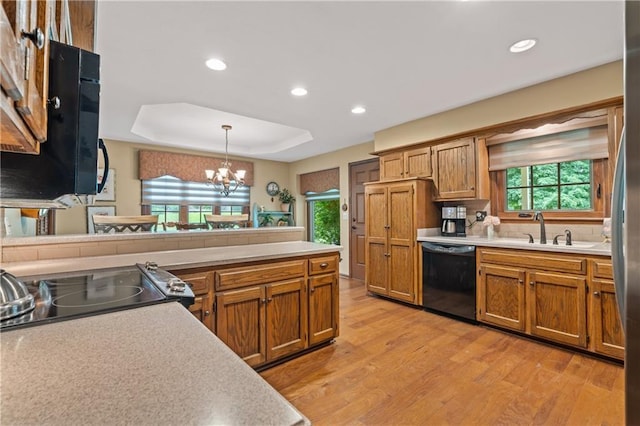 20129 W 112th Cir, Olathe, KS 66061 - kitchen with black appliances, light wood-style floors, a sink, light countertops, and recessed lighting