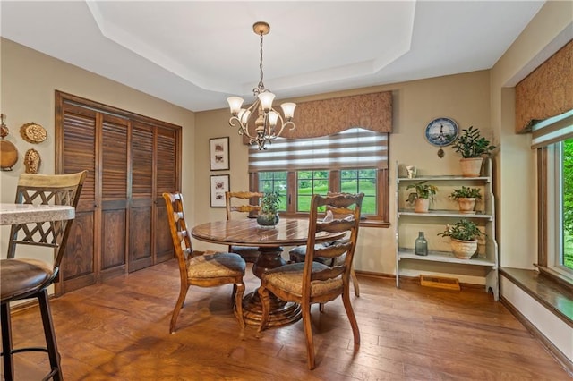 20129 W 112th Cir, Olathe, KS 66061 - dining area featuring a tray ceiling, a chandelier, hardwood / wood-style floors, and baseboards