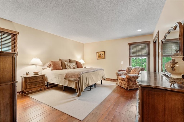 20129 W 112th Cir, Olathe, KS 66061 - bedroom with a textured ceiling, hardwood / wood-style floors, and baseboards