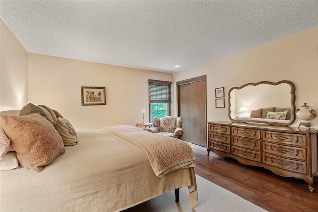 20129 W 112th Cir, Olathe, KS 66061 - bedroom featuring wood finished floors, a closet, and a textured ceiling