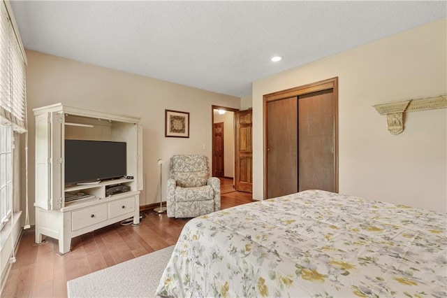 20129 W 112th Cir, Olathe, KS 66061 - bedroom with wood finished floors, a closet, recessed lighting, a textured ceiling, and baseboards