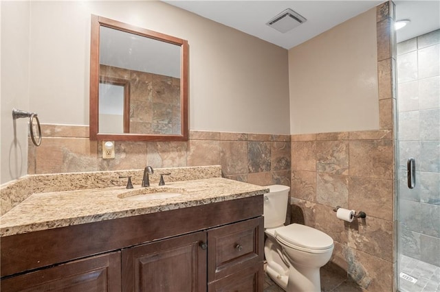 20129 W 112th Cir, Olathe, KS 66061 - full bathroom with tile walls, vanity, a stall shower, toilet, and wainscoting