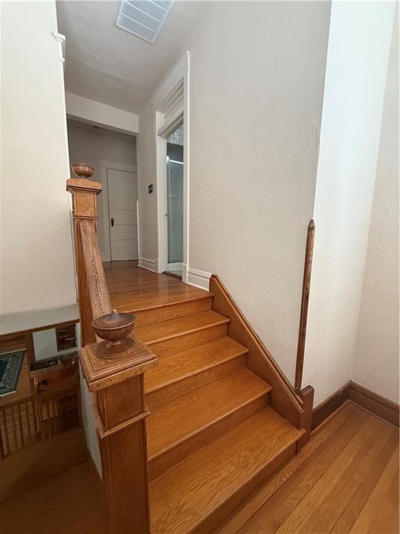 1701 Main St, Lexington, MO 64067 - stairway with wood finished floors and baseboards