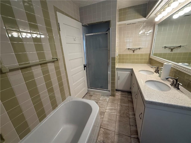 1701 Main St, Lexington, MO 64067 - bathroom featuring an enclosed shower, tile walls, double vanity, a bathtub, and decorative backsplash
