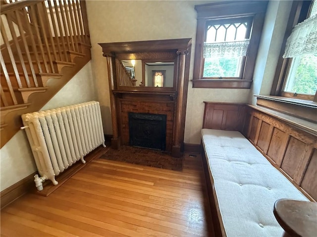 1701 Main St, Lexington, MO 64067 - living room with radiator, healthy amount of natural light, light wood-style flooring, and stairs