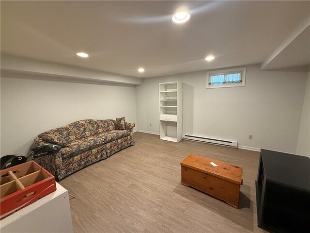 1701 Main St, Lexington, MO 64067 - living room with baseboard heating, wood finished floors, and recessed lighting