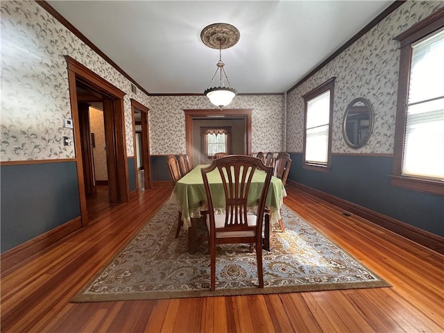 1701 Main St, Lexington, MO 64067 - dining area with wallpapered walls, crown molding, wainscoting, and wood finished floors