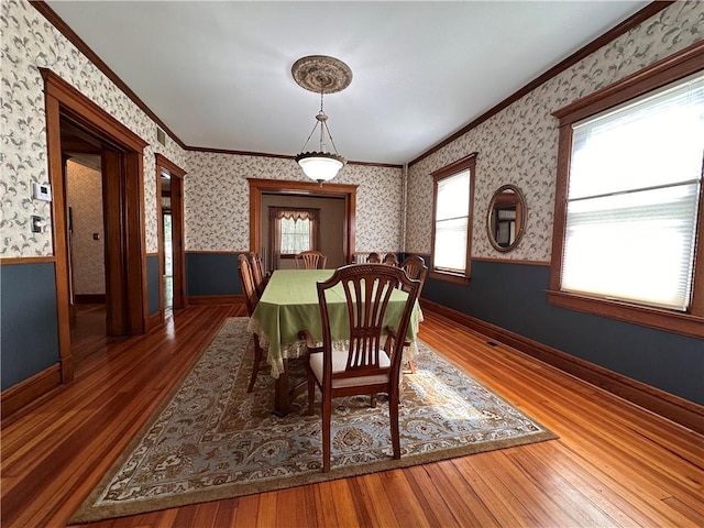 1701 Main St, Lexington, MO 64067 - dining room featuring wallpapered walls, ornamental molding, wood finished floors, and a wainscoted wall
