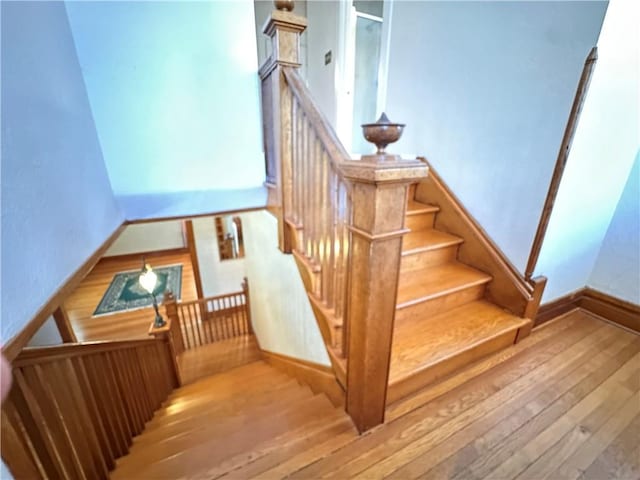 1701 Main St, Lexington, MO 64067 - staircase with hardwood / wood-style flooring and baseboards