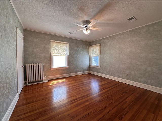 1701 Main St, Lexington, MO 64067 - unfurnished room featuring radiator, wood finished floors, ceiling fan, crown molding, and a textured ceiling