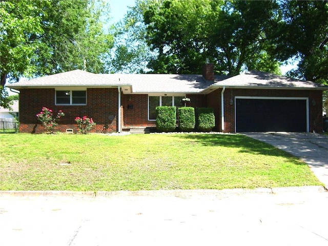 509 Pearl St, Pittsburg, KS 66762 - ranch-style house with an attached garage, brick siding, a front lawn, driveway, and a chimney