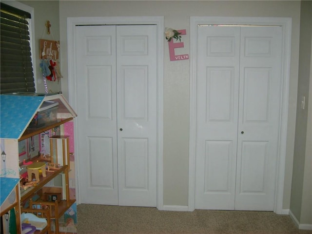509 Pearl St, Pittsburg, KS 66762 - bedroom featuring carpet floors, baseboards, and two closets