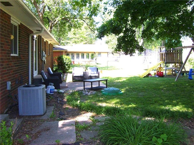 509 Pearl St, Pittsburg, KS 66762 - view of yard with central AC unit, a playground, and a patio area