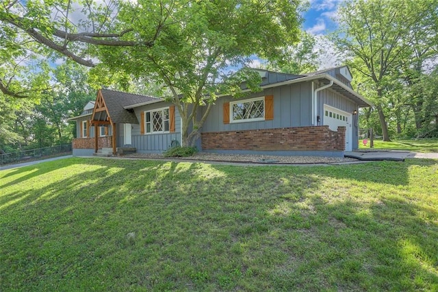 view of front facade featuring an attached garage, brick siding, a front lawn, and board and batten siding