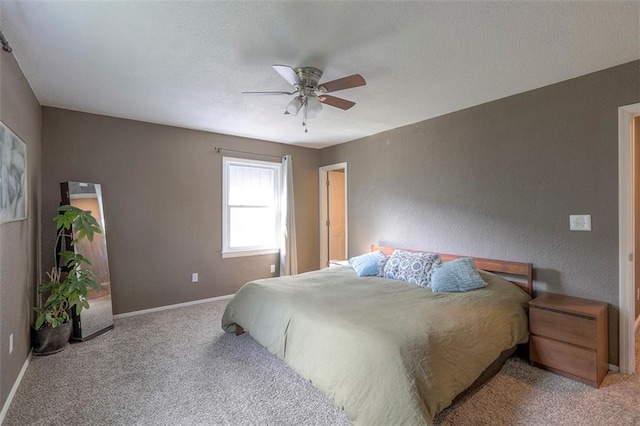 carpeted bedroom with baseboards and a ceiling fan