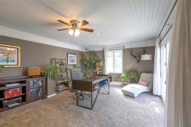 carpeted office featuring a ceiling fan, wooden walls, recessed lighting, and ornamental molding