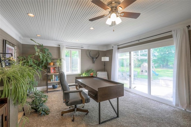 home office with carpet floors, a ceiling fan, recessed lighting, and wooden walls