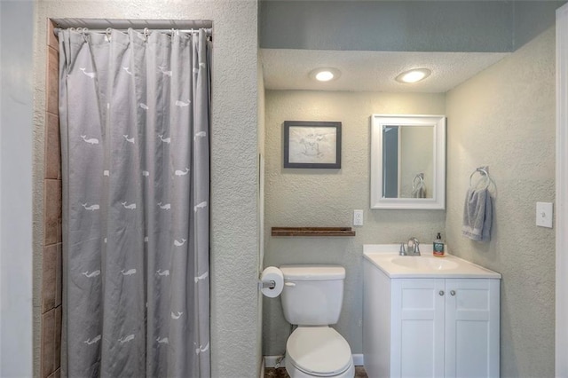 full bath with a textured wall, vanity, toilet, and a shower with curtain