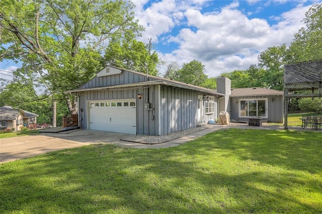 view of front of house featuring board and batten siding, a front lawn, concrete driveway, and a chimney