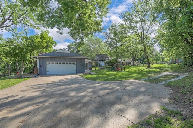 ranch-style house with board and batten siding, a playground, a front yard, an attached garage, and concrete driveway