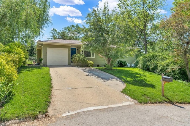 view of front facade with concrete driveway, a garage, and a front yard