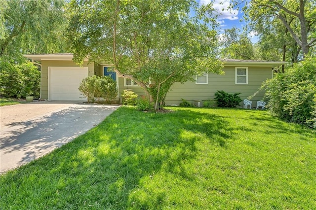 view of front of house featuring concrete driveway, a garage, and a front yard