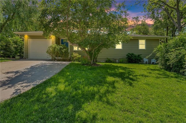 view of front of home with driveway, a garage, and a front lawn