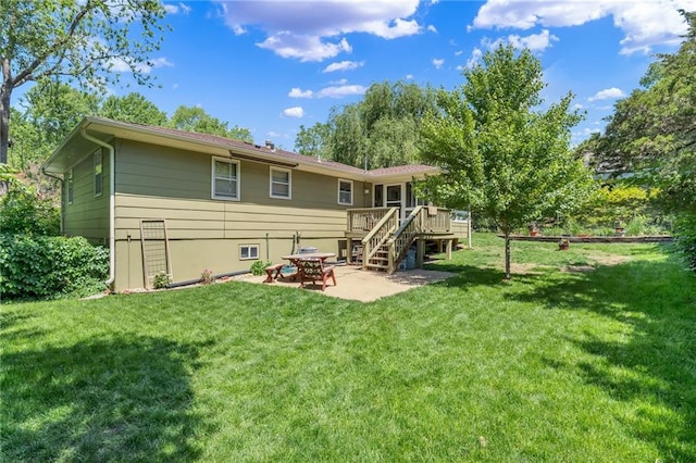 back of property with a deck, a patio, stairs, and a yard