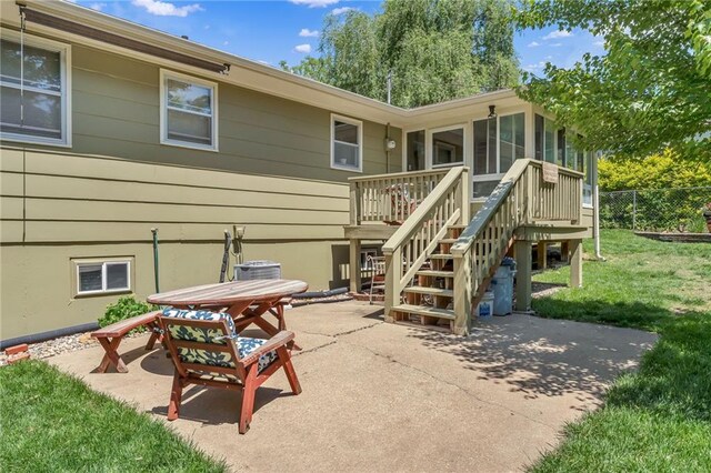 rear view of house with stairway, a patio area, a wooden deck, a sunroom, and central air condition unit