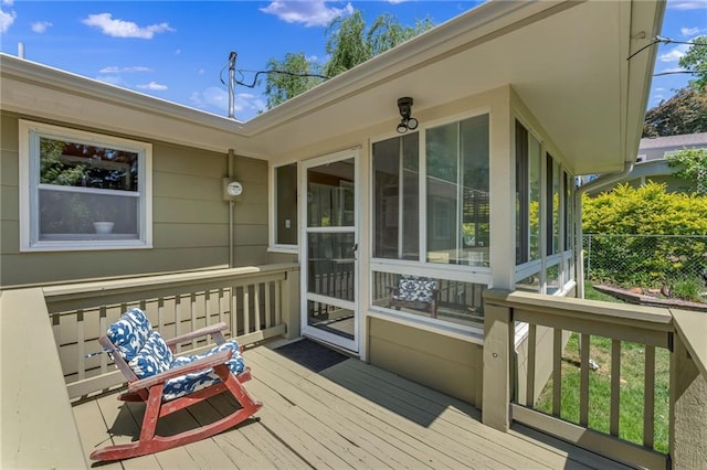 wooden terrace with a sunroom and fence
