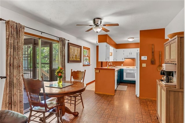 dining room featuring a ceiling fan, brick patterned floors, and baseboards