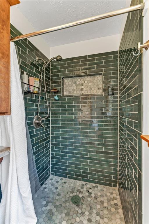 full bath featuring a tile shower