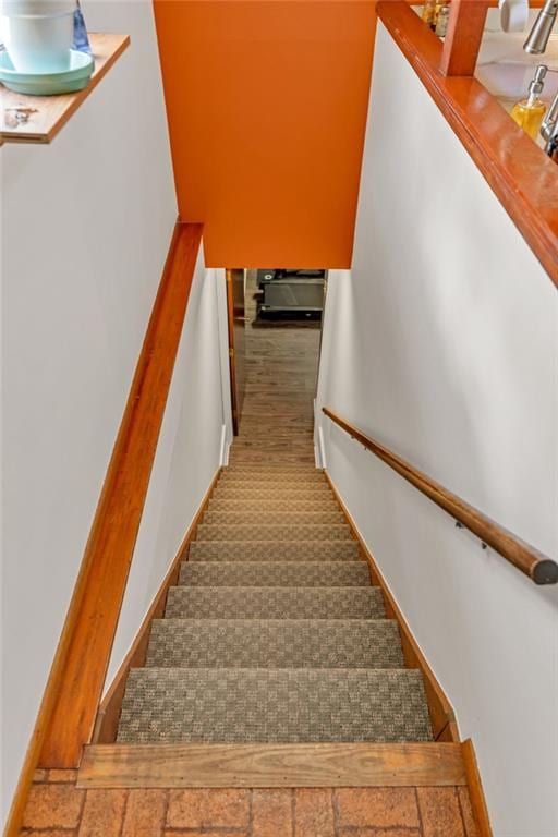 staircase featuring baseboards