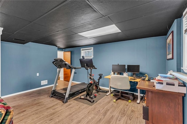 home office with wood finished floors, baseboards, and a drop ceiling