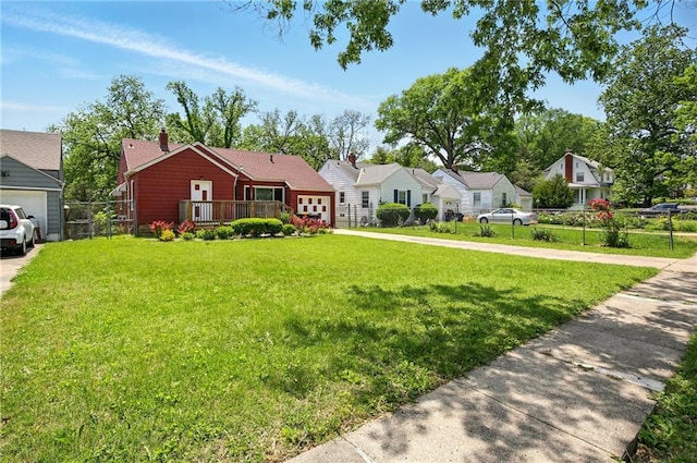 ranch-style house featuring concrete driveway, a garage, a deck, a chimney, and a residential view