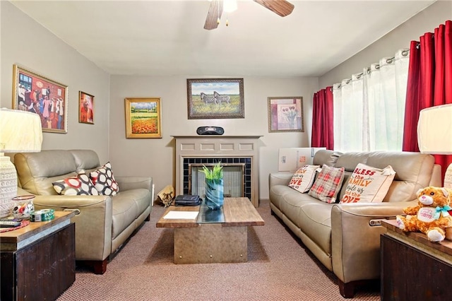 carpeted living area with a ceiling fan and a fireplace