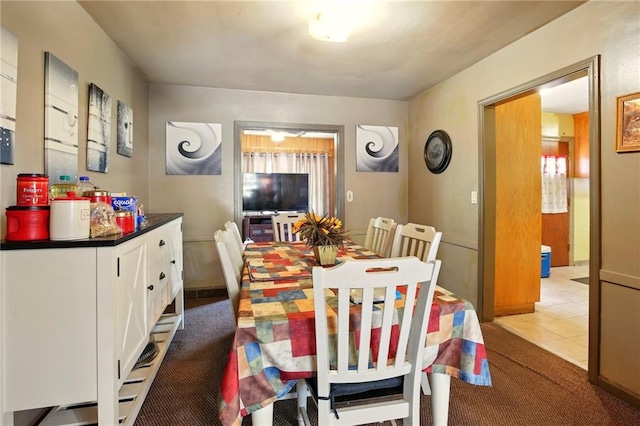 dining area featuring light colored carpet and light tile patterned floors