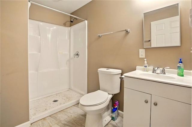 bathroom featuring a shower, vanity, toilet, and baseboards