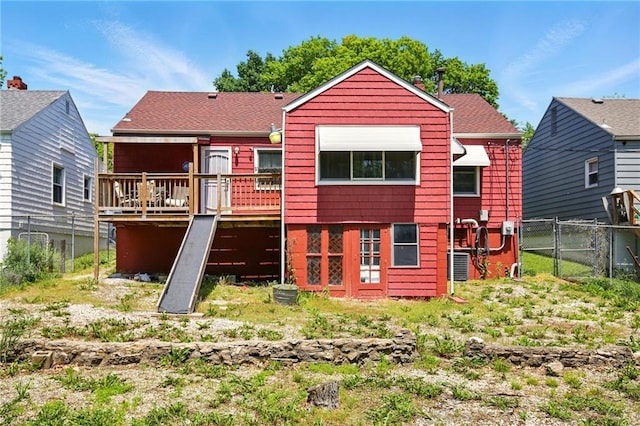 rear view of property featuring a wooden deck, fence, and central air condition unit