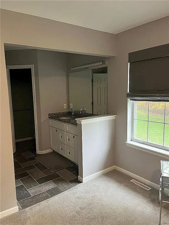 bathroom featuring baseboards and vanity