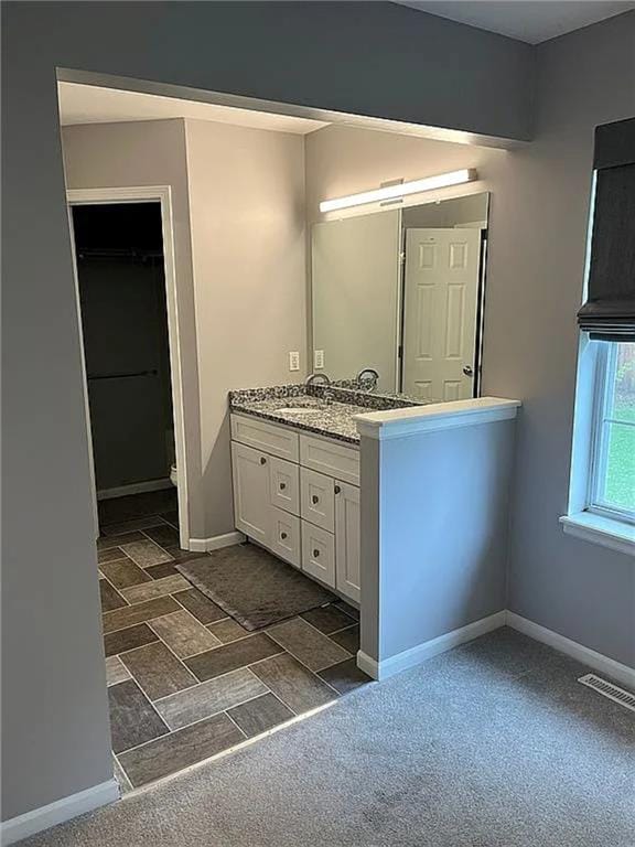 bathroom featuring vanity and baseboards