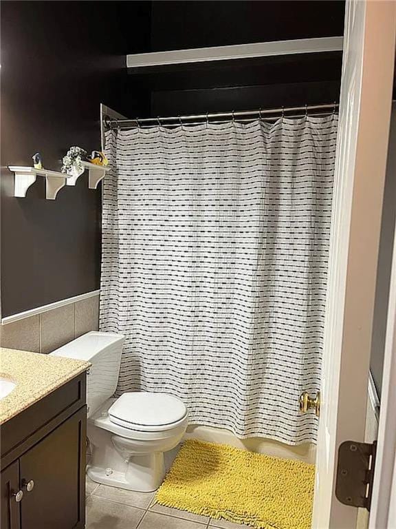 full bath with tile patterned floors, vanity, tile walls, toilet, and a shower with shower curtain