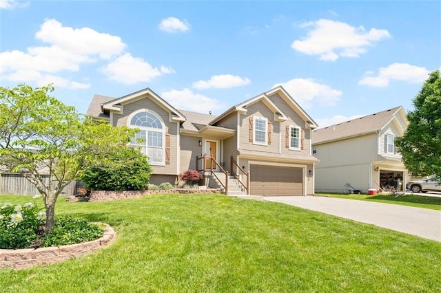 tri-level home with concrete driveway, an attached garage, and a front yard