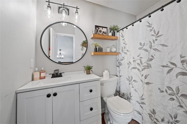 bathroom with a textured ceiling, toilet, and vanity