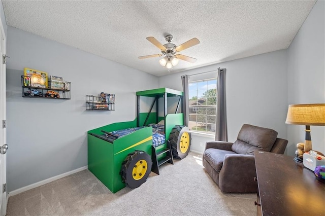 bedroom featuring carpet, baseboards, a textured ceiling, and ceiling fan