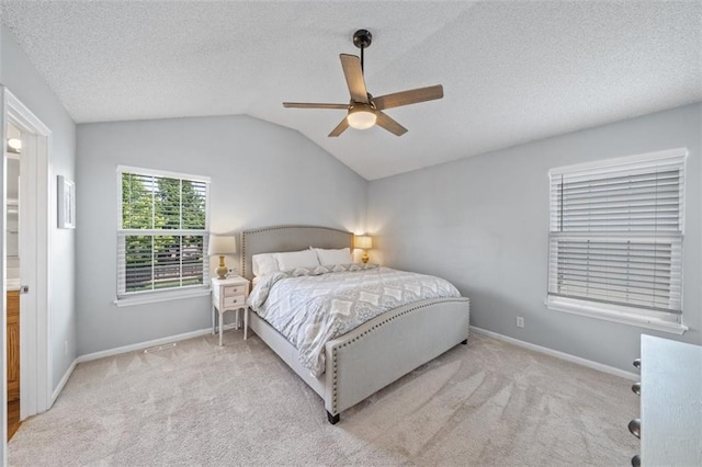 bedroom featuring a textured ceiling, lofted ceiling, carpet flooring, baseboards, and ceiling fan