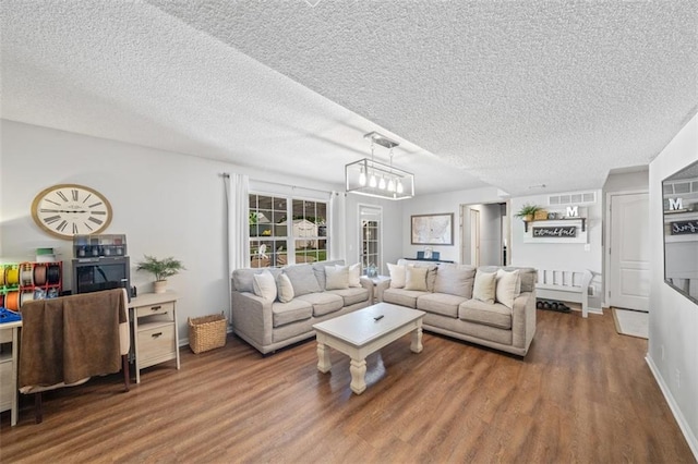 living area with wood finished floors and a textured ceiling