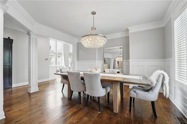 8833 N Crescent Ave, Kansas City, MO 64157 - dining area featuring a chandelier, dark wood-style floors, a wainscoted wall, a decorative wall, and ornamental molding